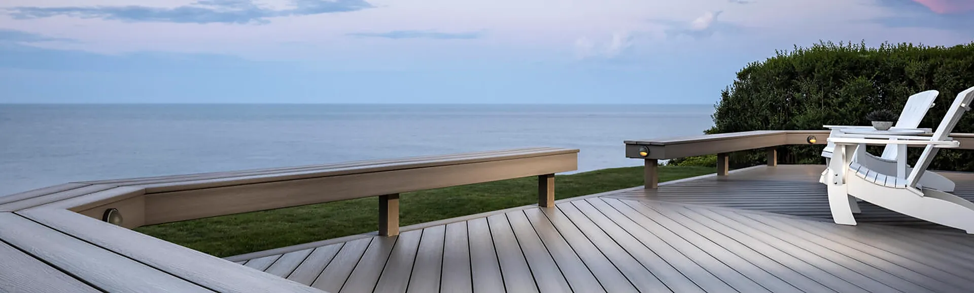 Luxury composite deck with ocean view and Adirondack lounge chairs